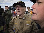 Hero: US war veteran Jim 'Pee Wee' Martin (center), 93, looks on after landing with a parachute on June 5, 2014 over Carentan, where he landed 70 years ago, when he was a paratrooper