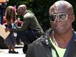 Sweet: Seal was seen giving his daughter Lou a hug as he visited his children's school for graduation day in Los Angeles on Wednesday