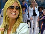 She's a model mom! Heidi Klum shows her fun side as she plays pat-a-cake with her four children at the airport