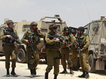Israeli soldiers deploy near the West Bank city of Hebron, Friday, June 13, 2014. Israeli soldiers searched the West Bank on Friday for three missing teenage...
