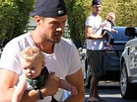 He's a handful! Josh Duhamel goes barefoot while carrying his adorable son Axl in his arms