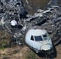 Chilling: An image taken on Monday shows the charred wreckage of the Gulfstream IV that erupted into flames near Boston on Saturday, killing seven