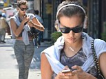 It seems to be working! Irina Shayk flashes toned midriff in crop top and tights after a gym session