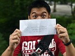 Winner!: Kurt Dee from Queens, New York, finds an envelope with money as part of the @HiddenCash scavenger hunt on June 14, 2014 in New York's Central Park