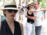 Hugging it out: Julianna Margulies cuts a stylish figure in Panama hat as she embraces male friend on streets of New York City