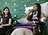 Emotional: Circus acrobats Julissa Segrera, (second from left, of the United States, and Dayana Costa, right, of Brazil,) are tearful as Costa reads a statement to members of the media at Spaulding Rehabilitation Hospital, Tuesday, June 17, 2014, in Boston