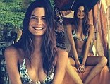 Behati Prinsloo displays her svelte figure in plunging patterned bikini as she enjoys a relaxed day at the beach