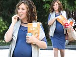 Eating for two! Heavily pregnant Alyssa Milano snacks as she shops while showing off bump in clingy blue dress