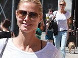 Pep in her step: Heidi Klum was stylish in grey stilettos as she perked up with a large Starbucks drink in New York on Saturday