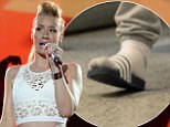 The show must go on! Iggy Azalea busts some moves hitting Miami stage in silver trainers after losing a toenail while playing soccer game