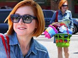 Alyson Hannigan shows off new short, orange-coloured 'do as she hits the market to buy some beach toys