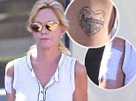 Wiping the slate clean: Melanie Griffith sports bandage on her arm as she begins painful tattoo removal procedure one month after filing for divorce