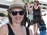Cat is away: Elisabeth Moss carried her cat in a bag on Monday as she caught a departing flight at Los Angeles International Airport