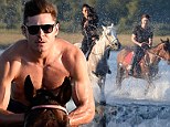 Her knight in glistening armour! Zac Efron whips his shirt off on amorous horse ride with Michelle Rodriguez
