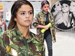 Suddenly shy? Selena Gomez cloaks her noticeably larger bust in a camouflage jacket hours after flaunting her cleavage in bra-top