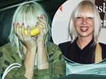 First you Sia her now you don't! Furler goofs around by hiding face in a BANANA while showing off bizarre arm drawings