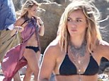 Ready for her comeback! Hilary Duff displays her slender figure in a black
bikini as she shoots her new music
video in Malibu