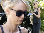 Sporty Kimberly Stewart dashes to her car wearing black cropped yoga pants and a flared tank top