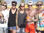 McBusted stag do: Shirltess Danny Jones looked to be having a whale of a time at Ocean Beach Ibiza with Dougie Poynter (centre), Matt Willis (second left), Harry Judd, James Bourne (left) and Tom Fletcher (right)