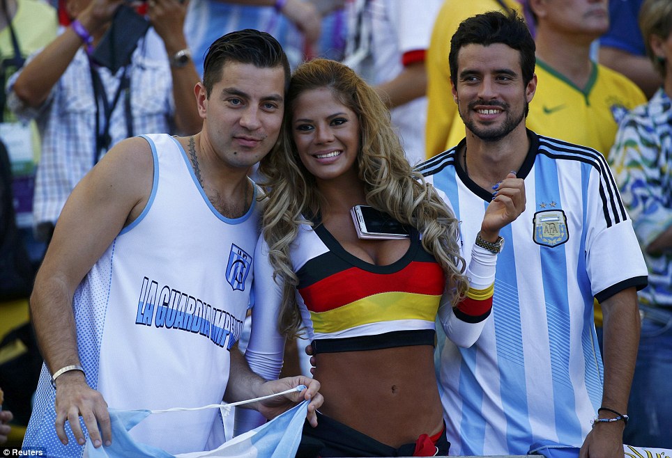 Friends: A Germany fan poses with a pair of Argentina supporters ahead of the 2014 World Cup final in Brazil