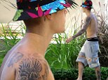 He loves to show off! Justin Bieber went for a shirtless stroll around his Beverly Hills home on Friday