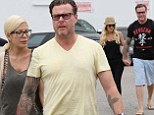 Tori Spelling and her husband Nick McDermott hold hands again as they repair their rocky marriage