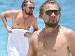 Feeling shy? Leonardo DiCaprio covers up with a towel after criticism that he¿s packed on pounds