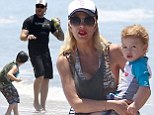 Tori Spelling keeps a close watch while Dean McDermott plays with their youngsters during another family day at the beach