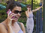 Good mood: Katie Holmes laughed while talking on her cell phone on Monday during a walk in New York City