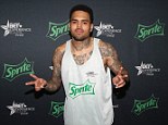 Making friends: Chris Brown, pictured last month, has rented a new home in Agoura, outside Los Angeles, and his new neighbour has warned the star stay on his side of the fence