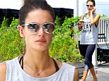 A bare-faced Alessandra Ambrosio wears a tank top and two-toned yoga pants while grabbing an iced drink and filling up her car with gas