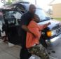 Heartbroken: Jamre Pearson is held back by a friend outside his home after his son was fatally shot
