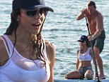 Bethenny Frankel sits back and enjoys the ride in wet crop top and cut-offs while paddleboarding with her brawny toyboy
