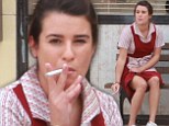Puffing away: Lea Michele, clad in a red waitress uniform, sat on a bench outside of a diner taking drags from a cigarette while on-set of hit series Sons Of Anarchy with actress Katey Sagal