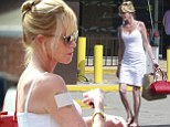 The big cover-up: Melanie Griffith steps out in stunning white sleeveless dress... as she continues to conceal 'Antonio' tattoo