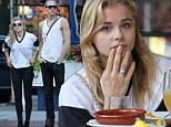 Make-up free Chloe Grace Moretz pairs a baggy white rugby shirt with skin-tight black trousers for a casual lunch with her brother