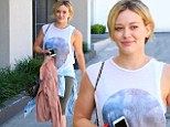 Someone's feeling sunny! Hilary Duff shows off her toned arms as she leaves the gym in a great mood