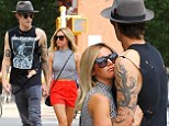 Lovebirds: Ashley Tisdale and her fiance Christopher French were seen hugging each other as they waited for a cab in New York City on Wednesday