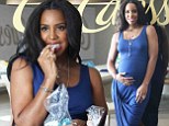 Must be a jelly baby! Kelly Rowland rubs her burgeoning belly after munching on sweets at pregnancy party in Beverly Hills