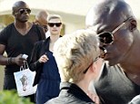 Seal shares a kiss with a young mystery blonde during cosy holiday stroll in Sardinia with his children
