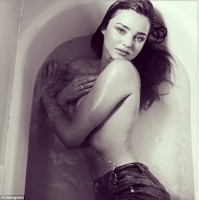 Something better to concentrate on: Miranda Kerr made mo mention of her ex-husband's spat as she posted a picture of herself topless in the bath today - taken from her new campaign for 7 For All Mankind jeans