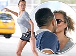 She's a real catch! Chrissy Teigen is rewarded with a kiss from husband John Legend after working up a sweat during energetic ball game