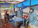 Medical workers in Sierra Leone wear protective clothing while treating patients infected with the Ebola virus in Kenema District