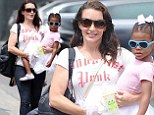 Doting mom: Kristin Davis carried her adopted daughter Gemma in her arms in Los Angeles on Saturday