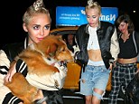 Miley Cyrus carries her new dog Emu after a concert in Philadelphia