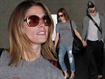 Home sweet home: Ashley Greene held the hand of her boyfriend, Australian TV personality Paul Khoury, as they exited the Los Angeles airport on Sunday