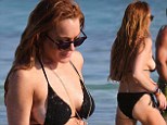 Not a supporting role! Lindsay Lohan puts on another side show in black string bikini while on vacation in Greece