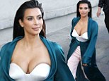 Kim Kardashian shows off ample cleavage in low-cut bustier and dressing gown coat as she leaves Jimmy Kimmel