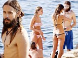 Soaking up all the attention! Shirtless Jared Leto frolics with three bikini-clad beauties on the beach in Ibiza