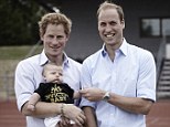 Hands full: Prince Harry and the Duke of Cambridge with a young Invictus Games supporter on Tuesday